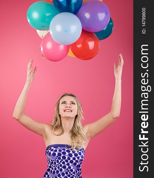 Pretty woman with colorful balloons on pink background. Pretty woman with colorful balloons on pink background