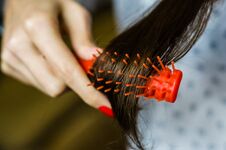 Free Young Brunette Woman Combing Her Brown Hair. Selective Focus Stock Images - 147935724