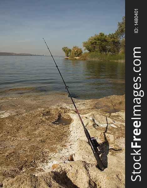 Fishing Pole Casted Alongside a Lake. Fishing Pole Casted Alongside a Lake