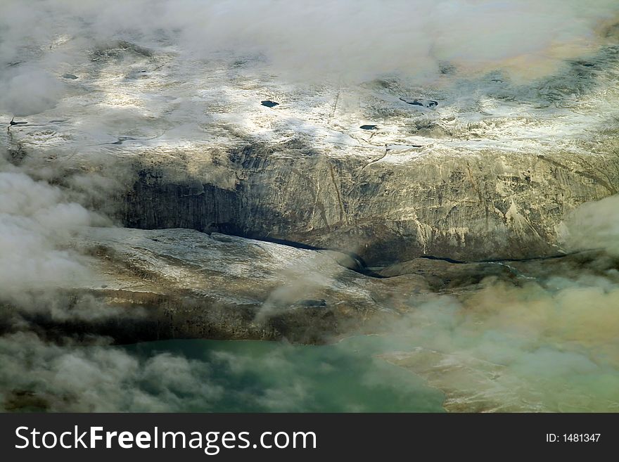 Snow covered mountain slopes and lake