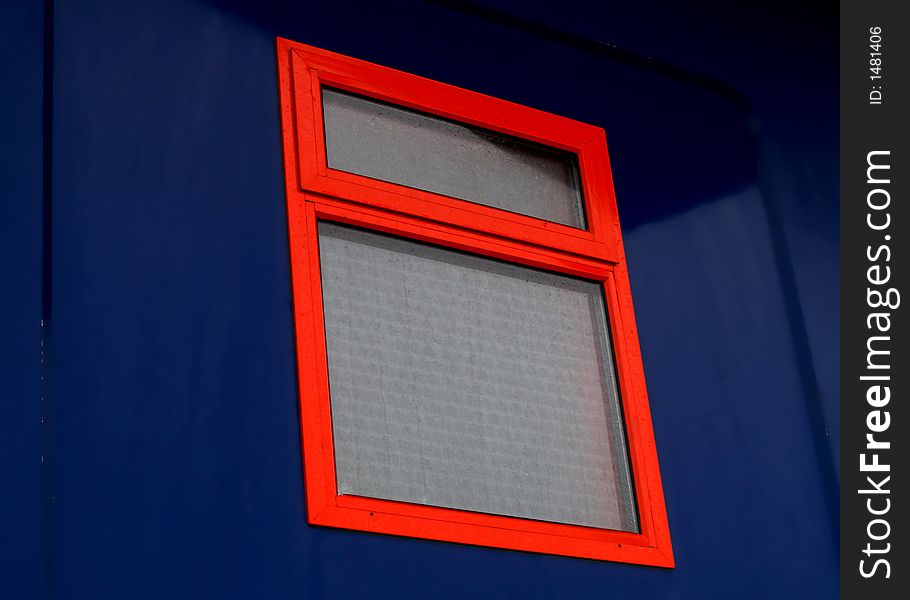 Red window frame with blue walls