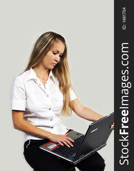 The attractive girl working with a computer. The attractive girl working with a computer