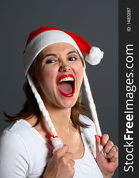 Brunette wearing a santa hat portrait. Brunette wearing a santa hat portrait