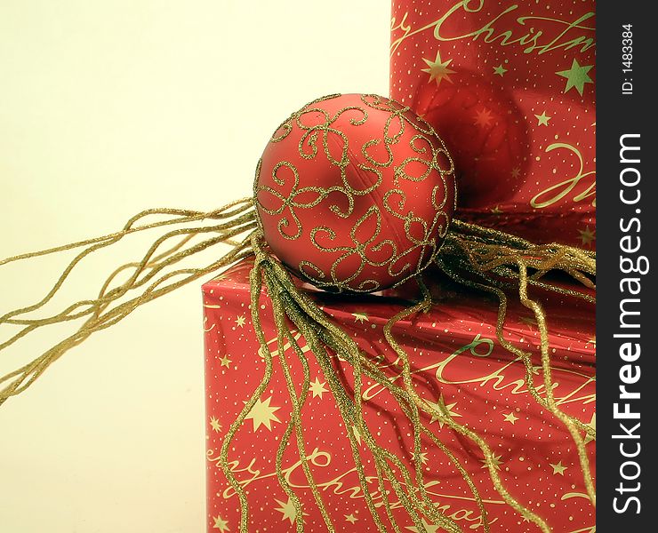 Red and gold wrapped presents with Christmas ornaments. Red and gold wrapped presents with Christmas ornaments