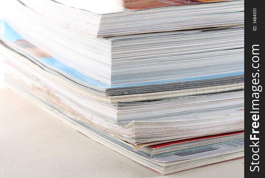 Stack of colourful magazines on white background. Stack of colourful magazines on white background