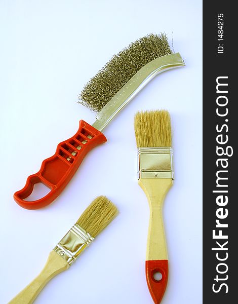 Two painting brushes and metal brush