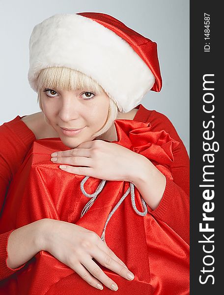 Beautiful girl with santa's hat and bag full of gifts. Beautiful girl with santa's hat and bag full of gifts