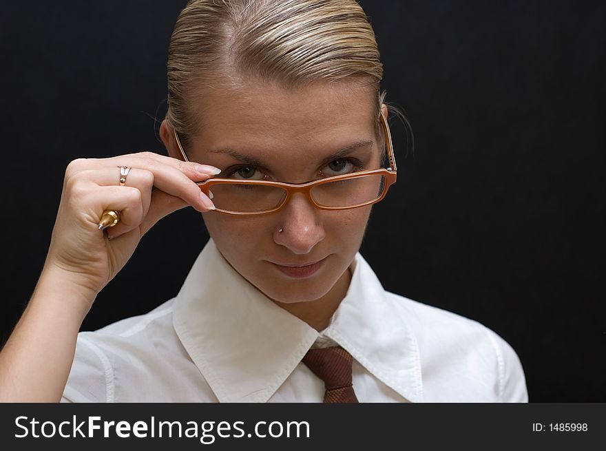 Business woman with pen and orange glasses isolated on black