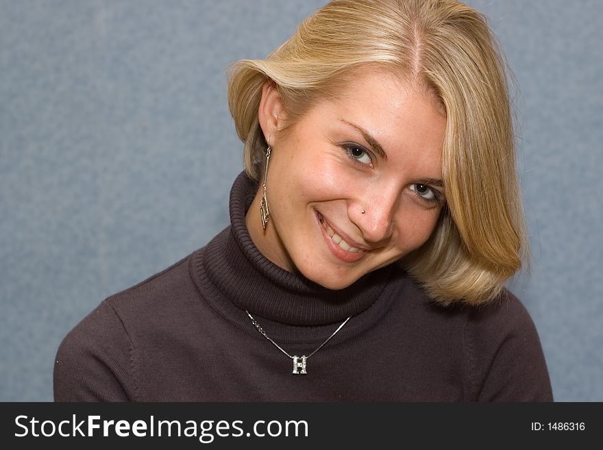 Portrait of a blond girl with blue background