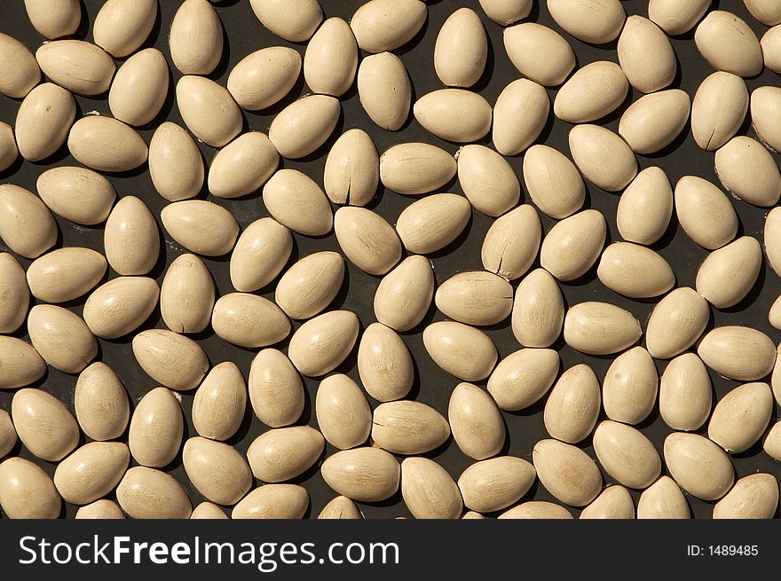 Chicken eggs cut in half and pasted on a wall.  They look like beans but they are really a sculpture like chicken eggs. Chicken eggs cut in half and pasted on a wall.  They look like beans but they are really a sculpture like chicken eggs.