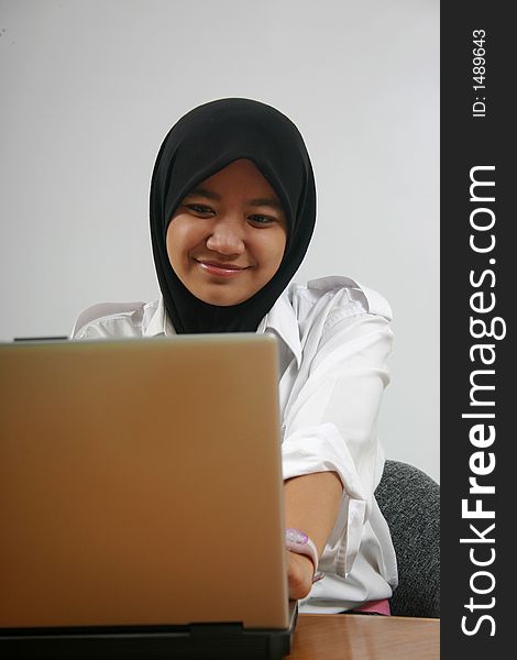 An asian girl using a laptop. An asian girl using a laptop.