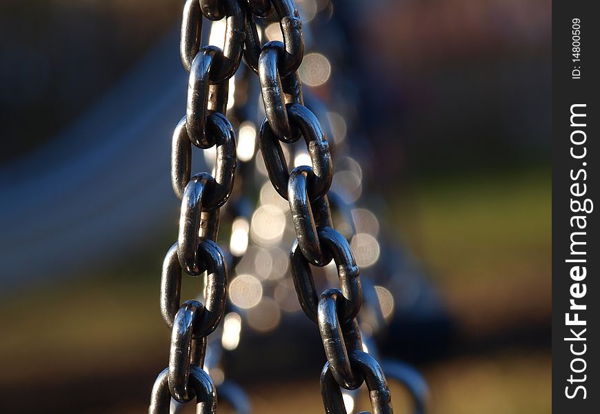 Swing chains in a playground on an autumn day