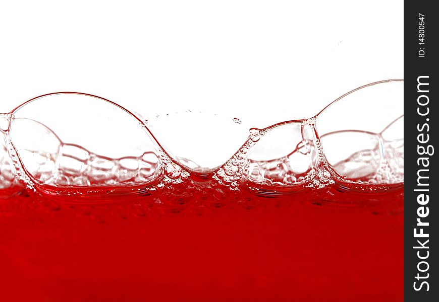 Red washing up liquid with soap bubbles. Red washing up liquid with soap bubbles