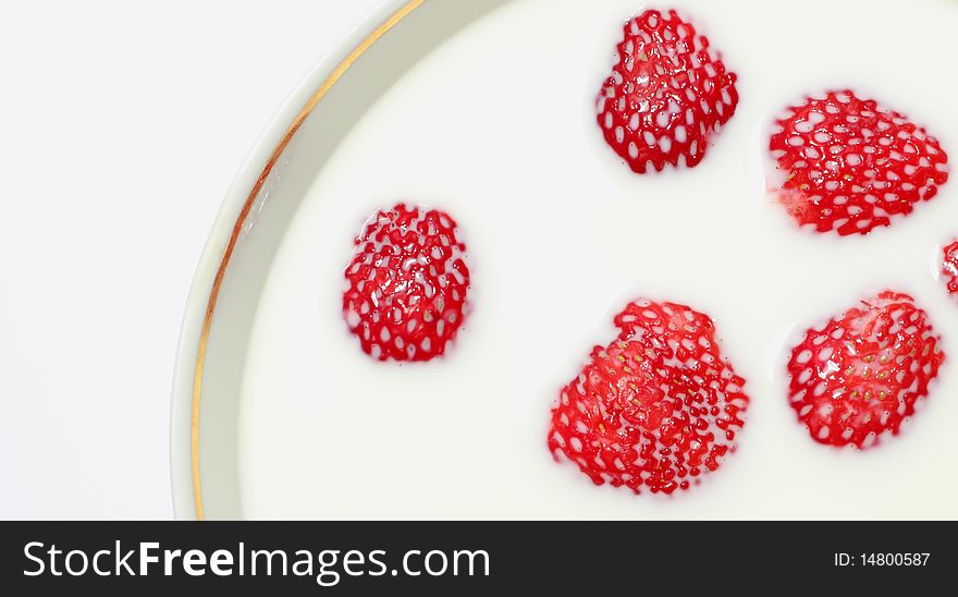 Strawberries in milk isolated on a white background. Strawberries in milk isolated on a white background