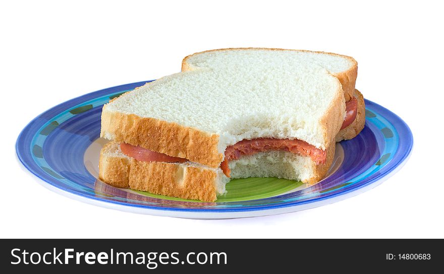 Sandwich with sausage on a plate .
