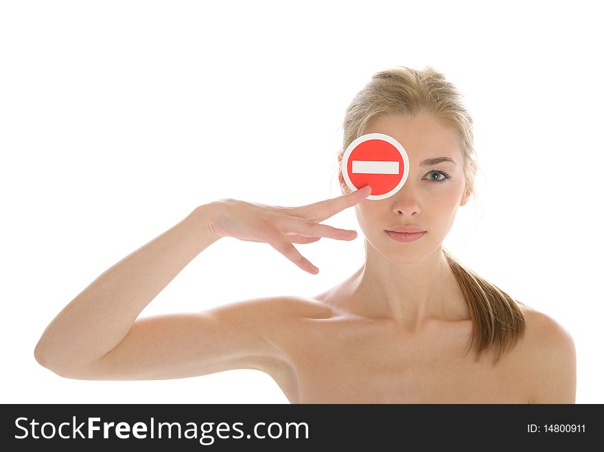 Beautiful young woman holds prohibiting sign isolated in white