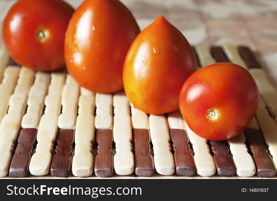 Red tomatoes on wooden decorative plates