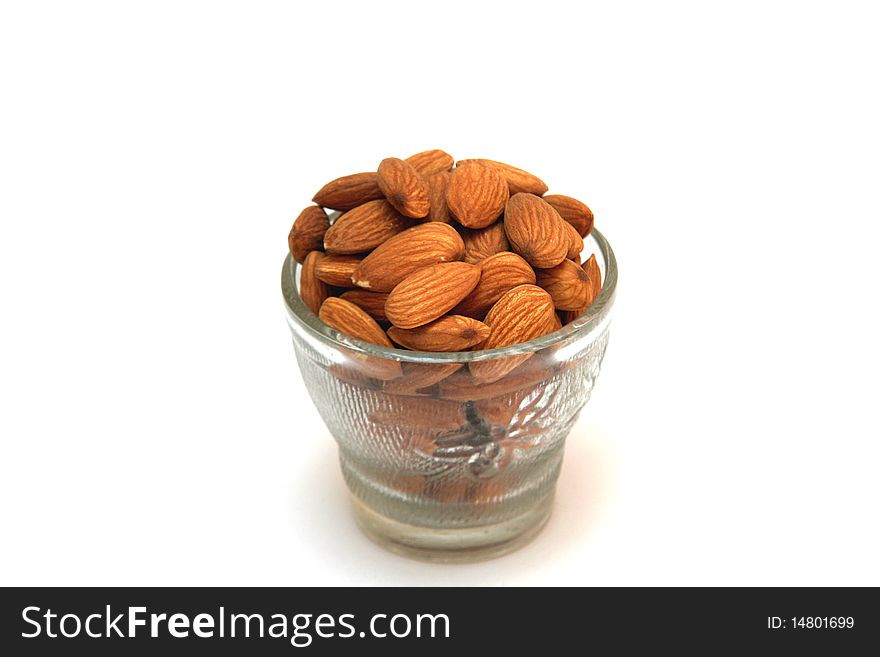 Cupful of healthy, tasty, yellow-brown  almond nuts. Cupful of healthy, tasty, yellow-brown  almond nuts