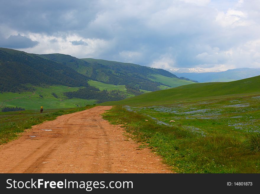 The shepherd on a horse in mountains