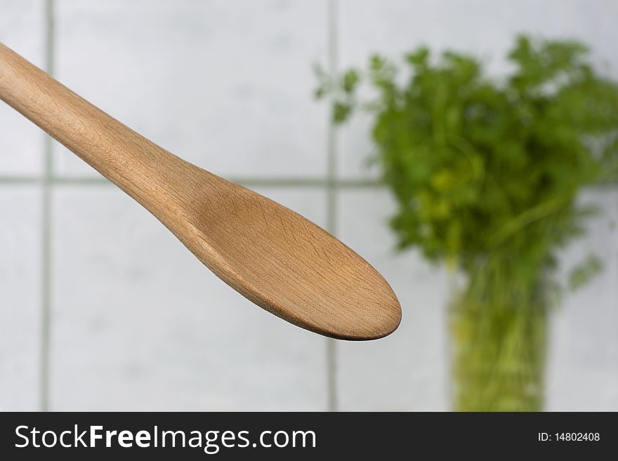Wooden spoon and parsley in background. Wooden spoon and parsley in background