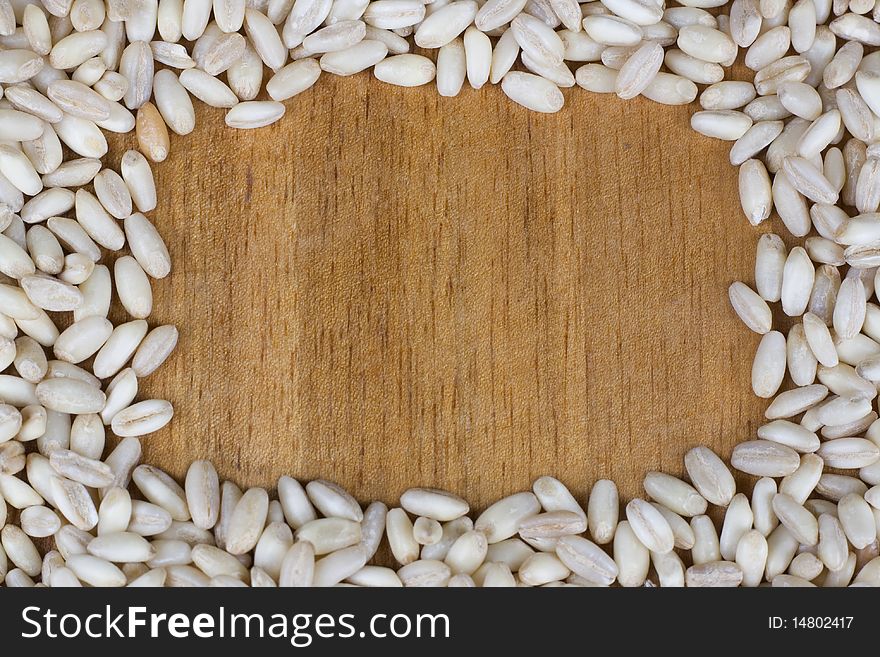 Frame of wheat on wooden background with copy space. Frame of wheat on wooden background with copy space