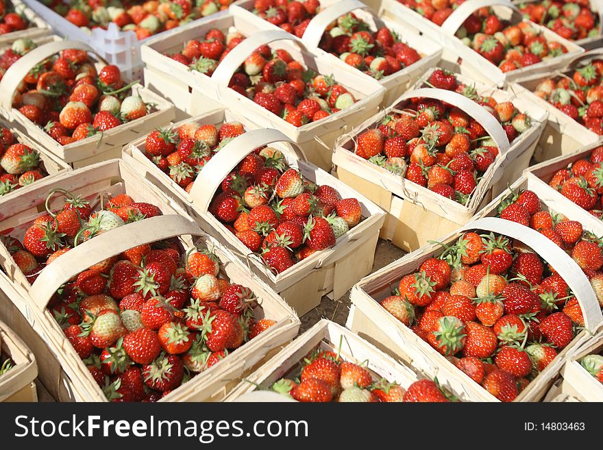 Ripe strawberries with leaves in baskets. Ripe strawberries with leaves in baskets