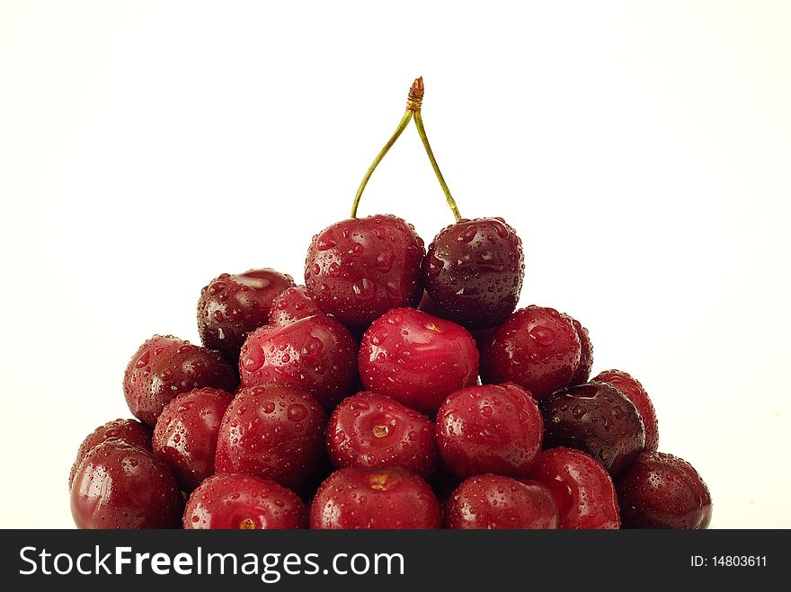 Sprinkled with water cherries on the white background. Sprinkled with water cherries on the white background