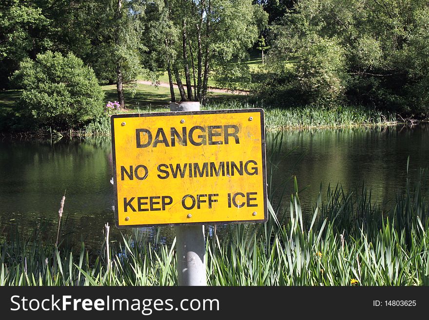 Danger sign next to a lake. Danger sign next to a lake