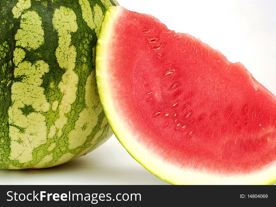 Piece cut out of watermelon on the white background. Piece cut out of watermelon on the white background
