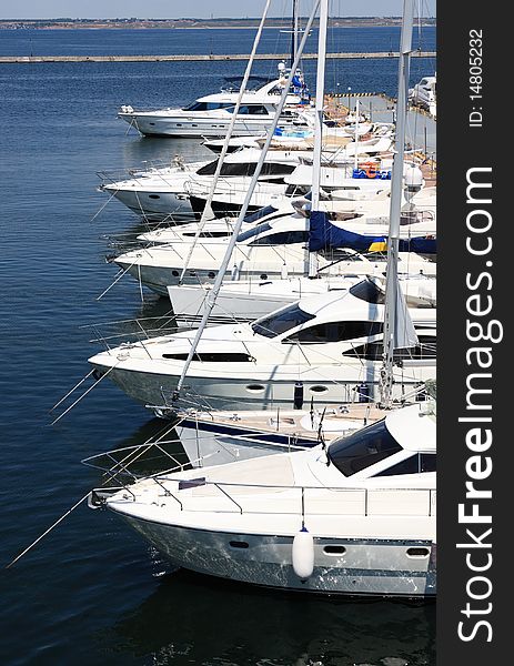 Row of luxury yachts mooring in marina