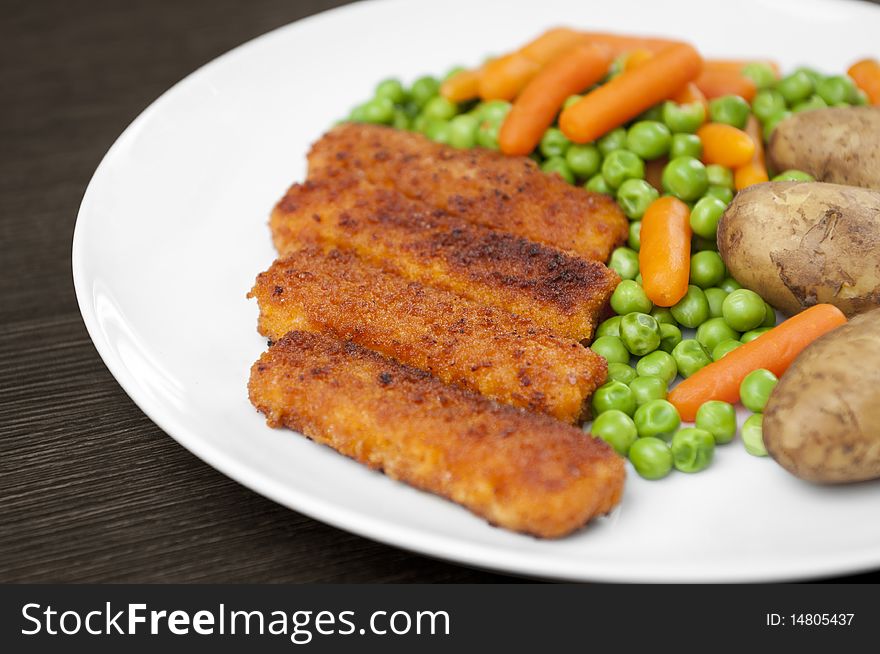 Fish finger meal with peas, carrots and potatoes. Fish finger meal with peas, carrots and potatoes