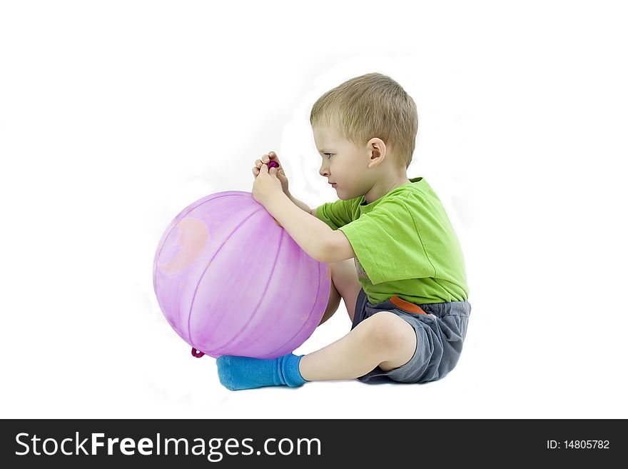 The serious boy with a ball on a white background. The serious boy with a ball on a white background