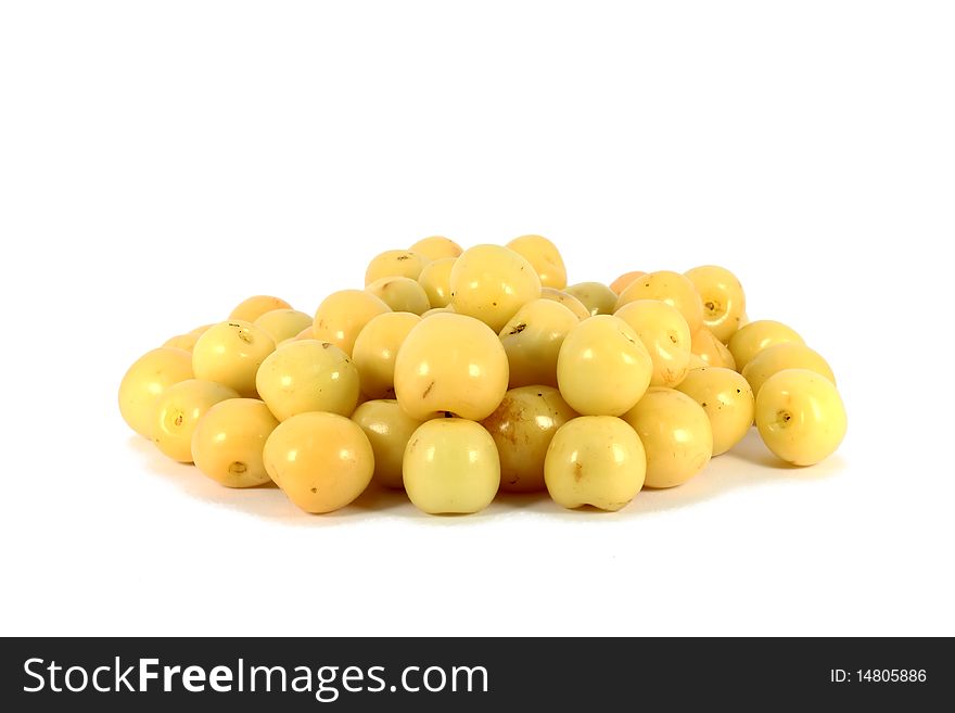 Heap of sweet yellow cherries isolated on white