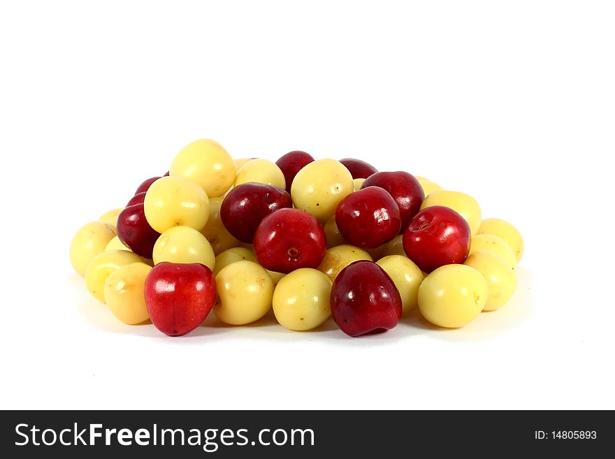 Heap of sweet red and yellow cherries isolated on white