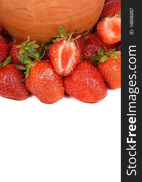 Ceramic pot and strawberry on white