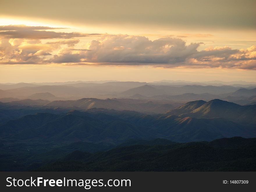 A cloud and mountain range before sunset