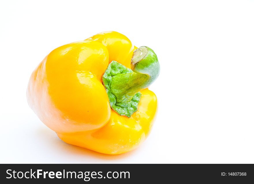 A yellow paprika on white background