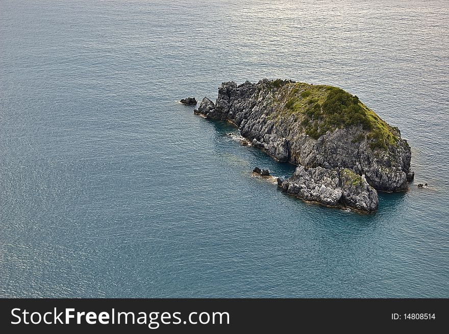 Small island in front of italian coastline