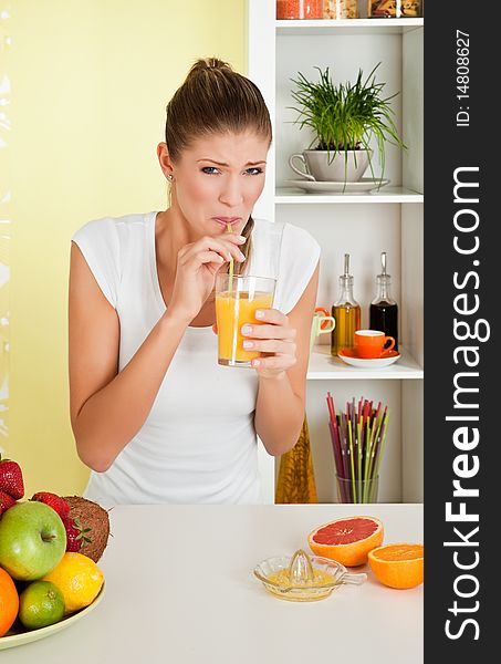 Beauty, young girl drinking acid orange juice at home