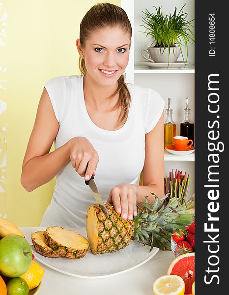 Beauty, young girl slicing pineapple and smiling