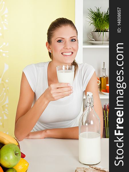 Beauty, young girl holding a glass of milk and smiling