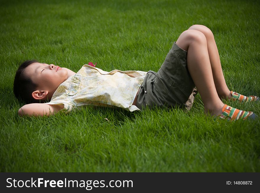 The boy sleeping on the grass. The boy sleeping on the grass