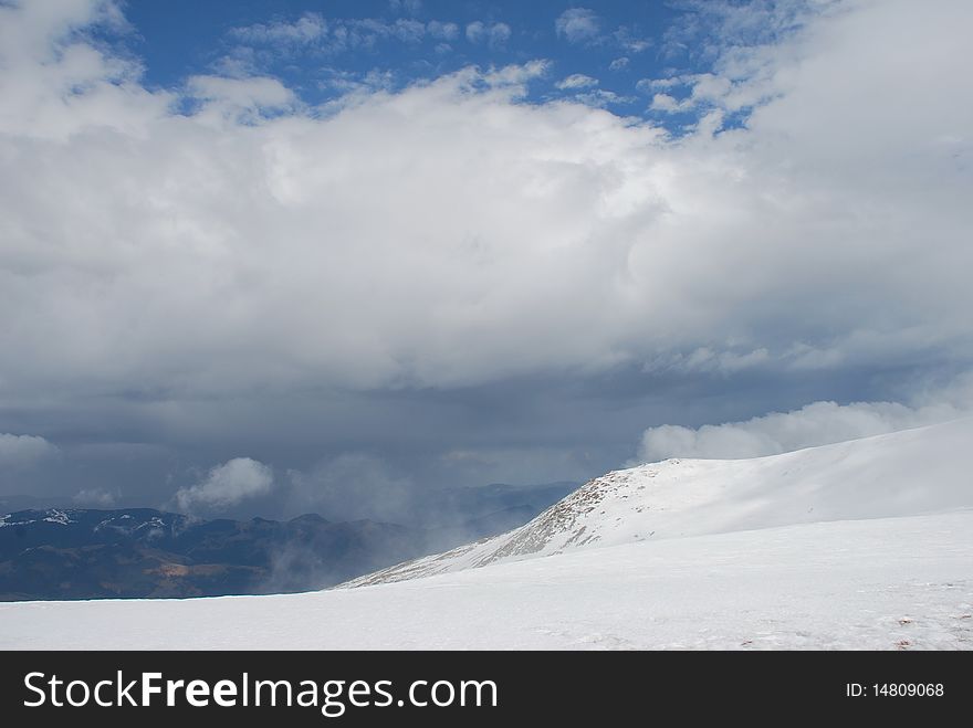 Mountain Winter Slope In Clouds.