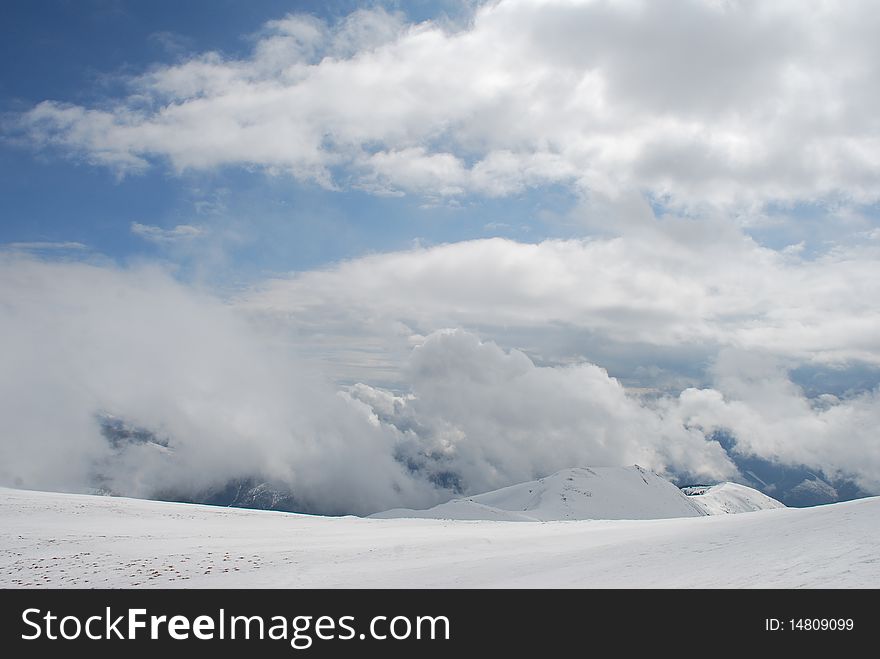 Mountain Winter Slope In Clouds.