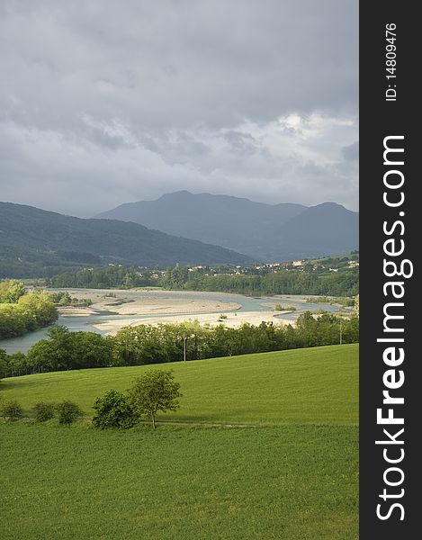 Landscape mountain. In season rains, the river full branches and the water takes a green emerald, opening in the sky cloudy allowing the sun to pass through. Landscape mountain. In season rains, the river full branches and the water takes a green emerald, opening in the sky cloudy allowing the sun to pass through