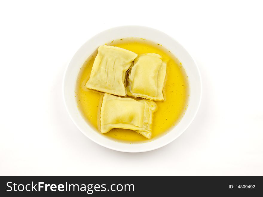 Pasta squares in clear soup, isolated on white background