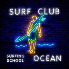 Surfing Poster In Neon Style. Glowing Sign For Surf Club Or Shop. Surfboards Electric Icons On Brick Wall Background Stock Photography