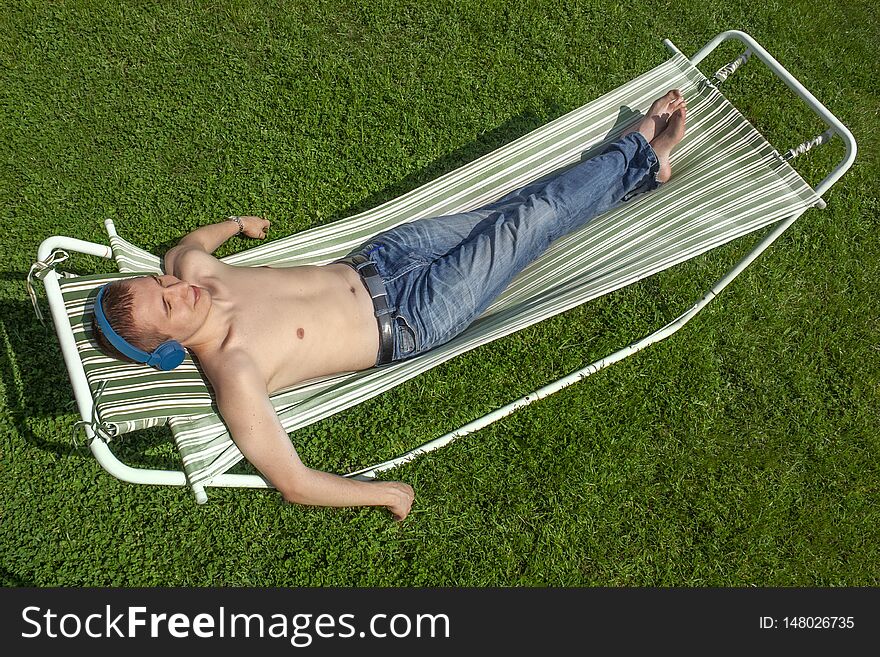 The guy is resting in a hammock