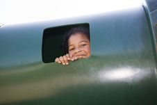 Little Girl Peeking Out Window At Playground Royalty Free Stock Image
