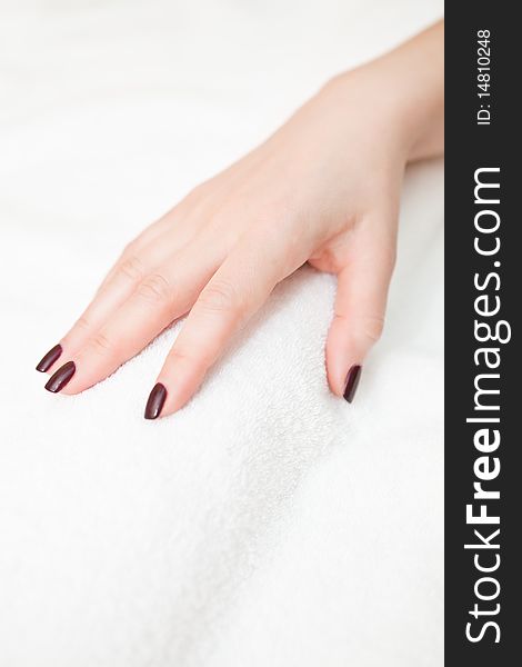 Female hand on a white terry towel. Female hand on a white terry towel